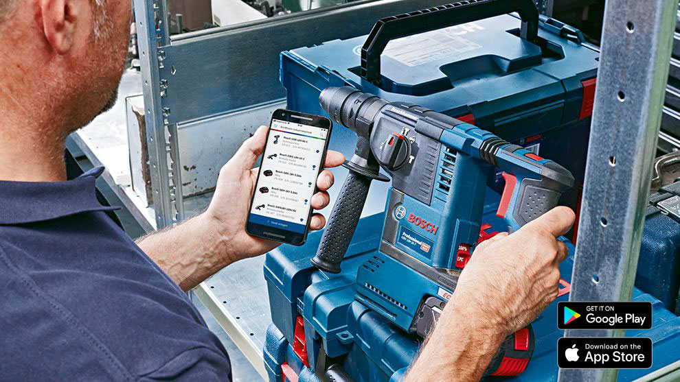 Downloading PRO360 App A man holds a smartphone and operates a Bosch Professional drill.