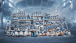 Various Bosch Professional tools on shelves in an industrial hall.