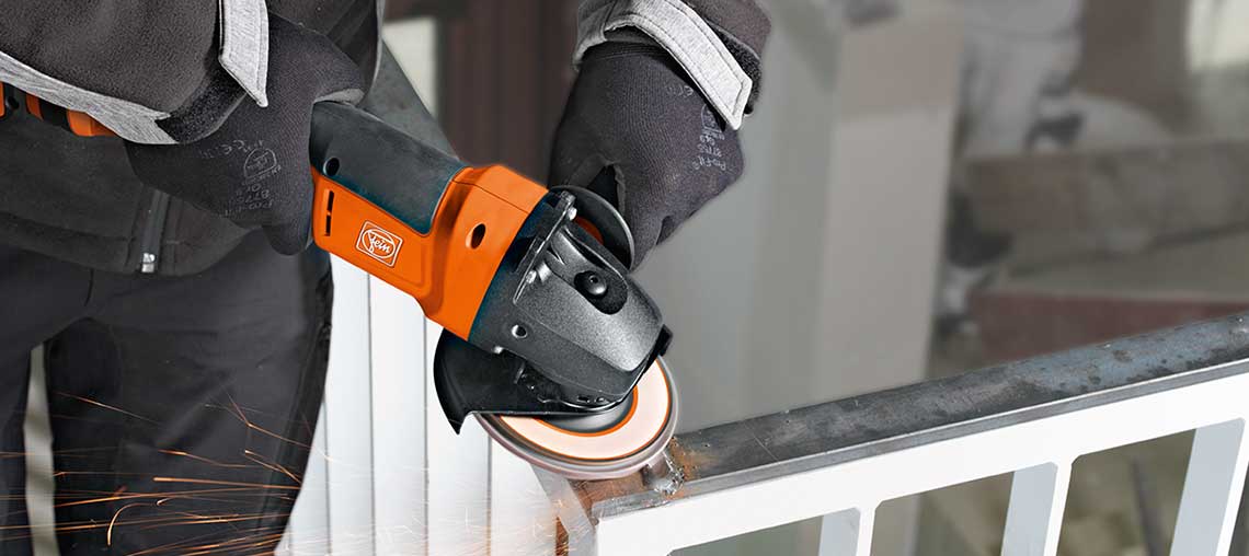 A Bosch Professional angle grinder cuts metal, sparks fly.