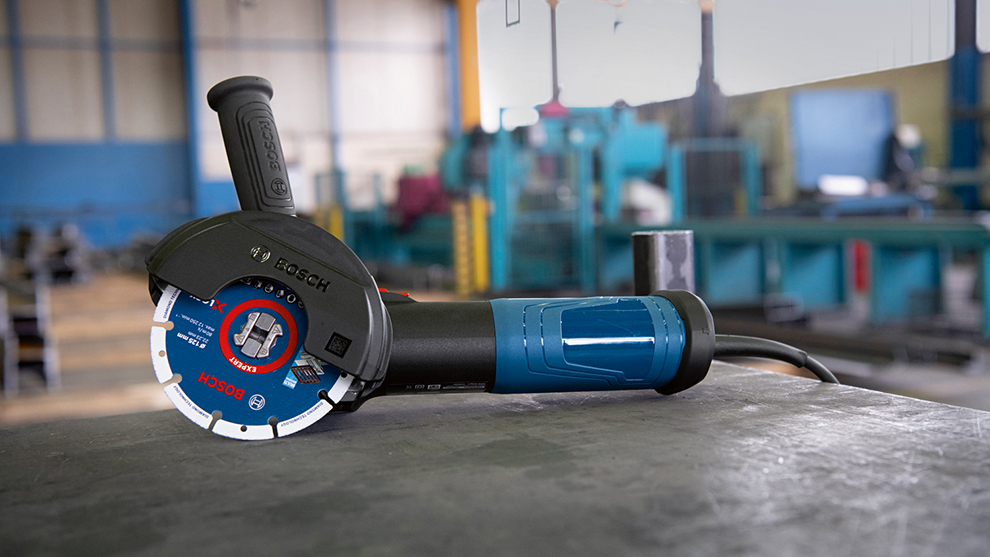 A Bosch Professional angle grinder with a blue handle on a table.