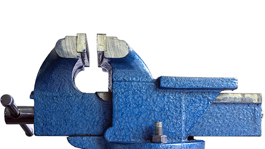 A blue metal vise on a white background.