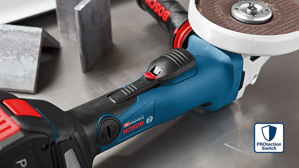 Blue Bosch Professional angle grinder on metal surface with accessories.
