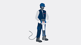 A construction worker with a blue helmet is operating a Bosch Professional hammer.