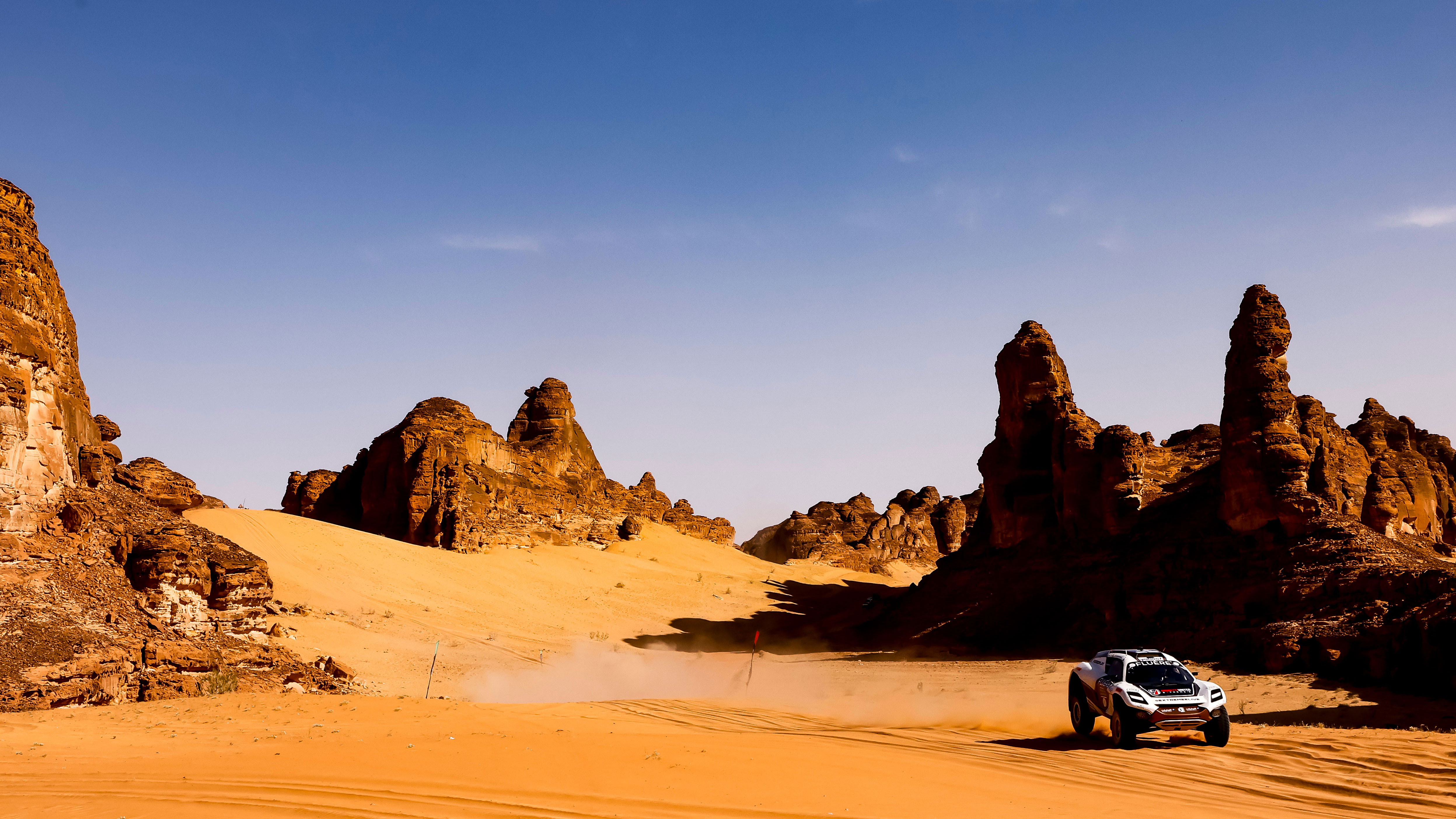 It's getting hot in here: In Al'Ula, Saudi Arabia, the unforgiving desert landscape puts Extreme E racers and Bosch Professional tools to the ultimate test. A white off-road vehicle drives through a sandy desert landscape.