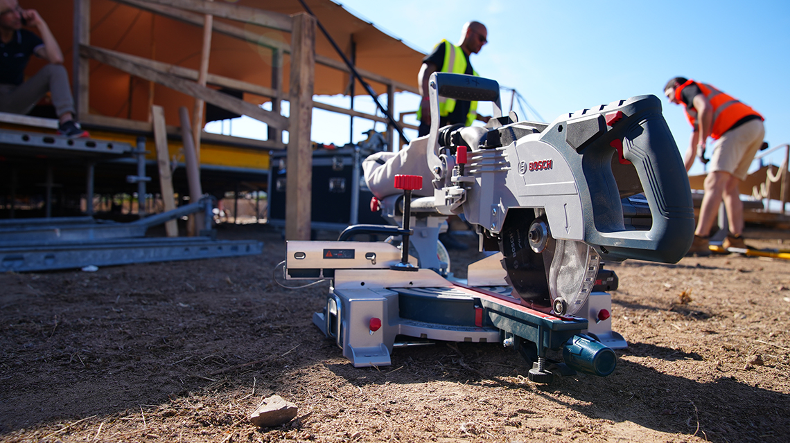 A Bosch Professional miter saw is standing on the floor.