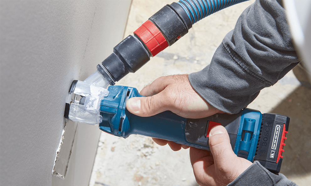 A Bosch Professional tool cuts into a wall opening.