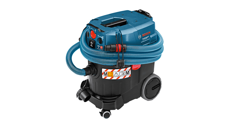 A blue Bosch Professional vacuum cleaner with hose and wheels.