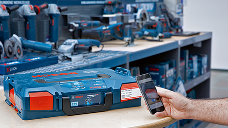A Bosch Professional tool case is on a table, next to a mobile phone.