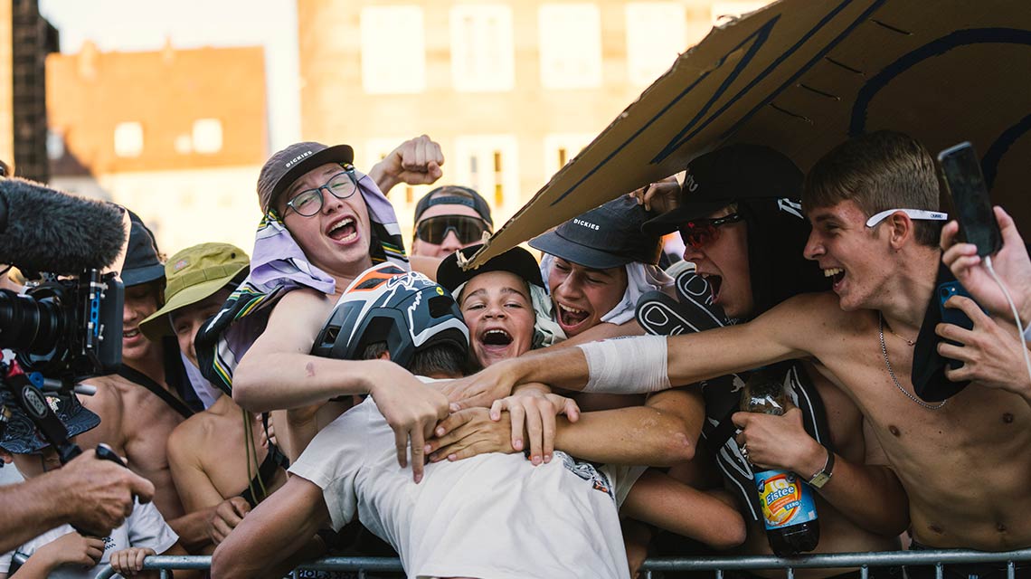 Young people celebrate enthusiastically with joyful faces and hats.