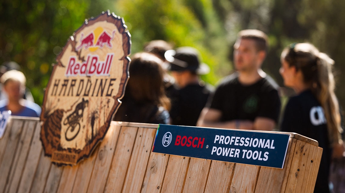 Bosch Professional sign in front of Red Bull Hardline event with spectators.