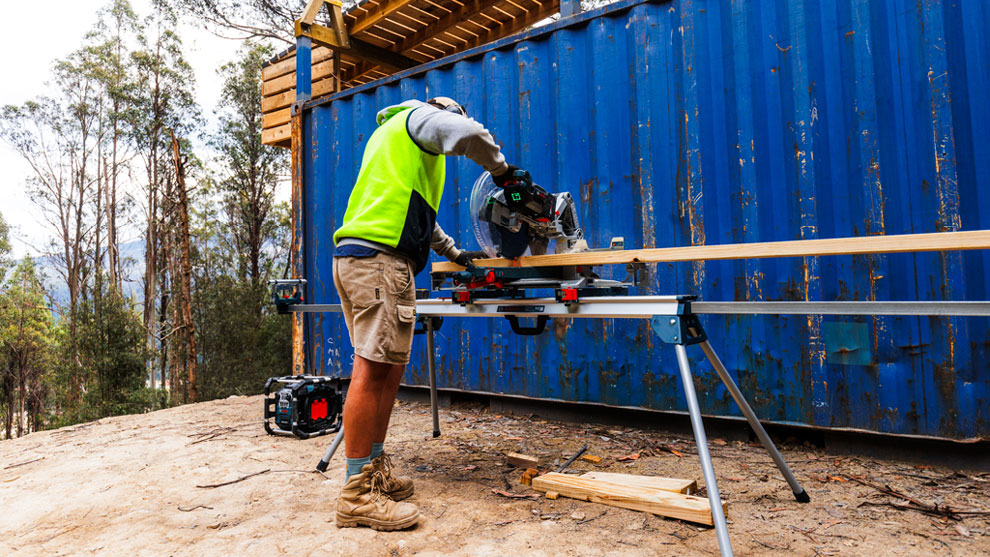 BUILT WITH BOSCH A craftsman is cutting wood with a Bosch Professional circular saw.