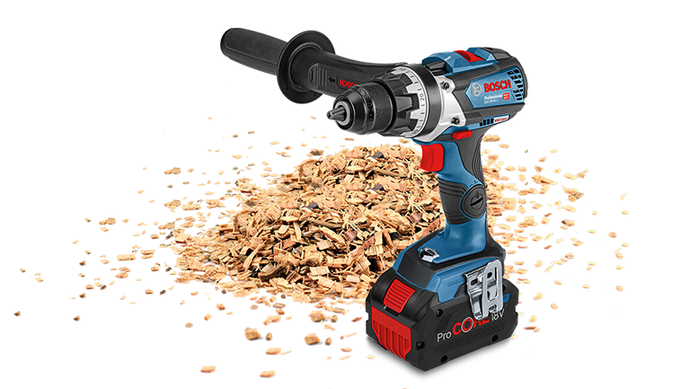 A blue Bosch Professional cordless drill stands on wood shavings.