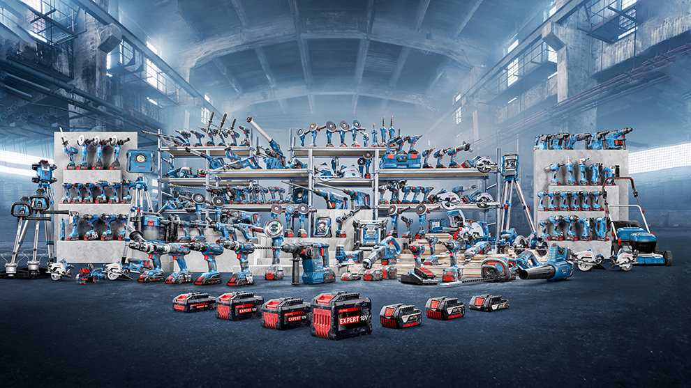 Diverse blue Bosch Professional tools on shelves in a hall.