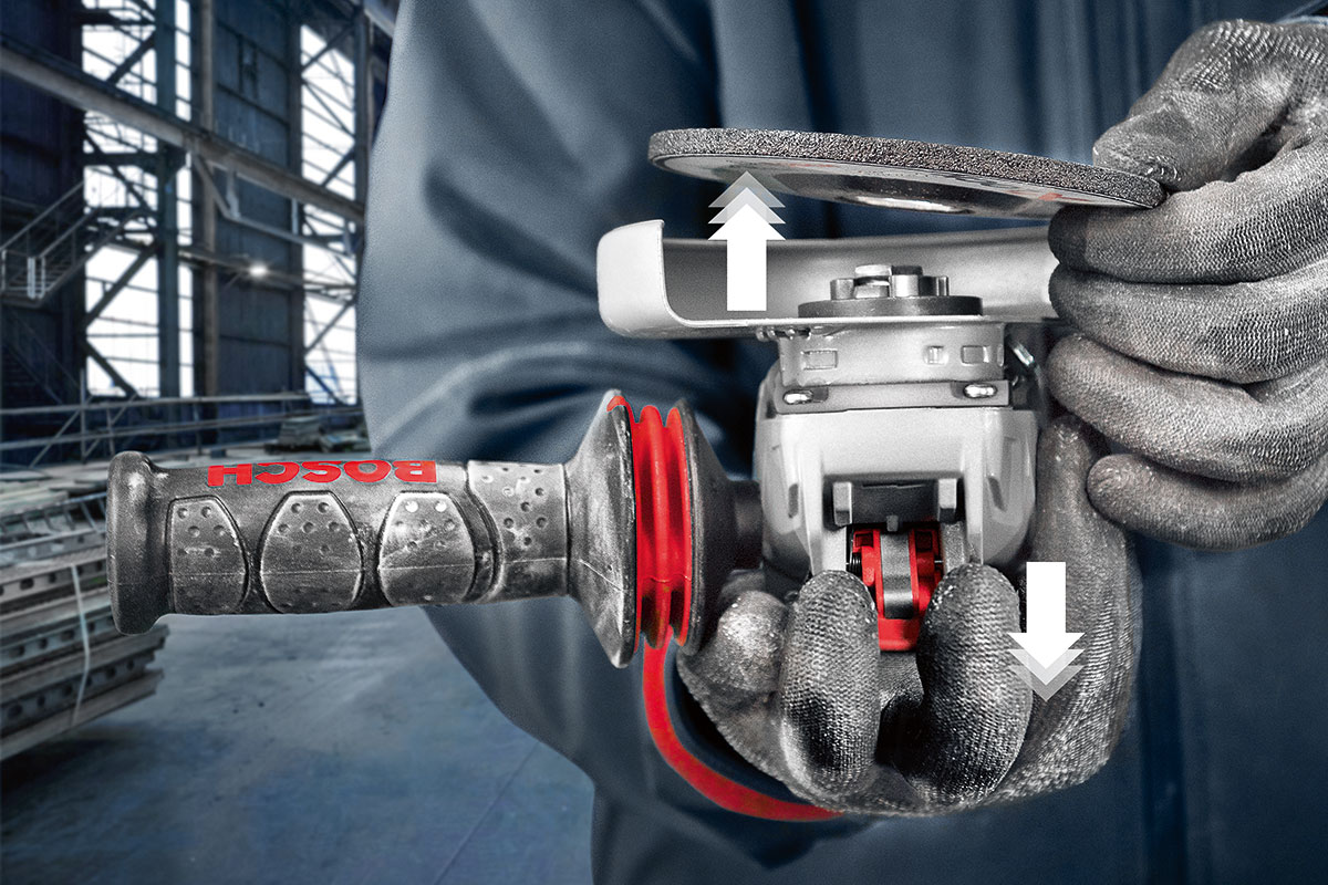 Two hands hold a Bosch Professional sander in a workshop.