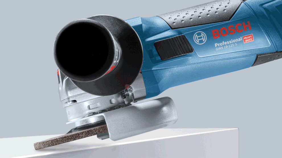 Blue Bosch Professional angle grinder stands on a white surface.
